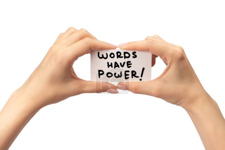 Words have power text on a card in a woman hand isolated on a white background.