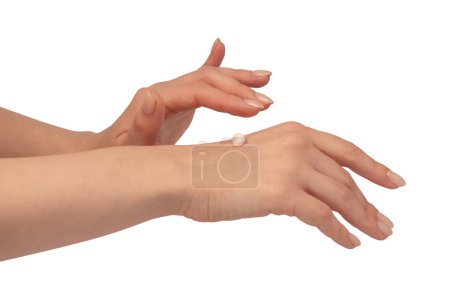 Beige cream tube in woman hands isolated on a white background. Cream swatch on woman hand.  Skin care concept.
