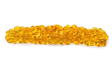 A group of yellow capsules isolated on a white background. 