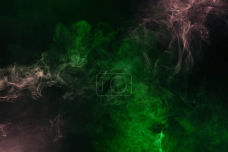 Photo for Green and pink steam on a black background. Copy space. - Royalty Free Image
