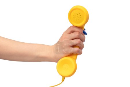 Yellow handset in woman hand isolated on white. Copy space.