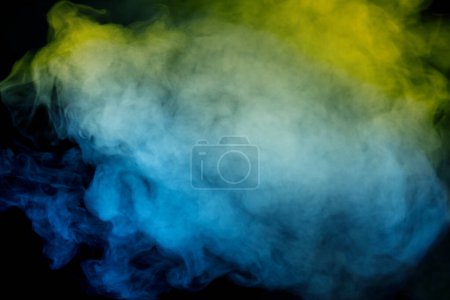 Photo for Blue and yellow steam on a black background. Copy space. - Royalty Free Image