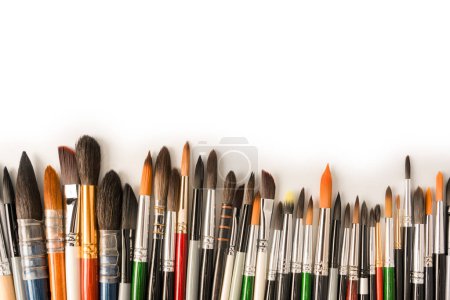Photo for Mix of paint brushes in a row isolated on a white background.  Top view. - Royalty Free Image