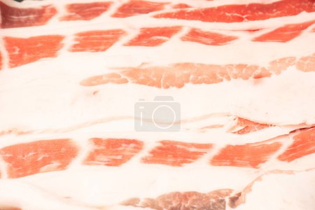 Photo for Tasty raw bacon as a background. Top view. - Royalty Free Image