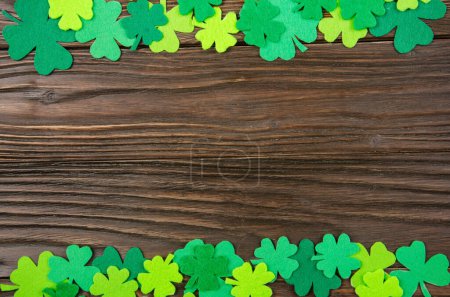 Photo for Happy Saint Patrick's mockup of handmade felt shamrock clover leaves on wooden background. - Royalty Free Image