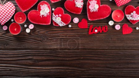 Photo for Sewed handmade fabric hearts and aroma candles for valentine day on dark wooden background with copy space - Royalty Free Image
