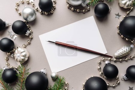 Photo for Set of vintage dip pen, inkpot and blank paper sheet with envelope on white wooden table - Royalty Free Image