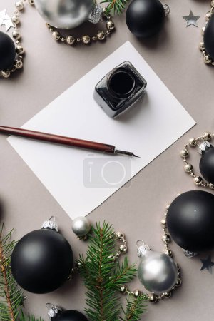Photo for Set of vintage dip pen, inkpot and blank paper sheet with envelope on white wooden table - Royalty Free Image
