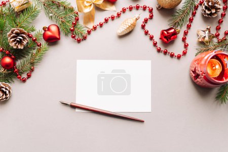 Foto de Conjunto de bolígrafo de inmersión vintage, tintero y hoja de papel en blanco con sobre en mesa de madera blanca, decoración de Navidad - Imagen libre de derechos
