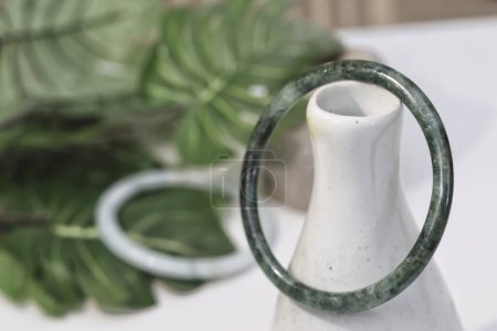 Photo for Jade bangle product with tropic leaves - Royalty Free Image