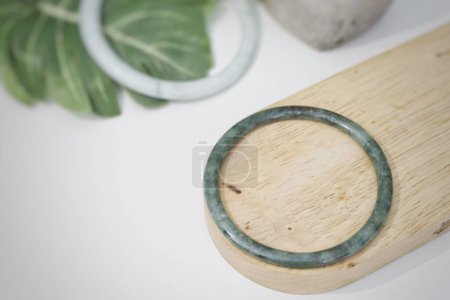 Photo for Jade bangle product with tropic leaves - Royalty Free Image