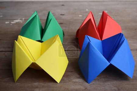 Origami paper fortune teller on wood background