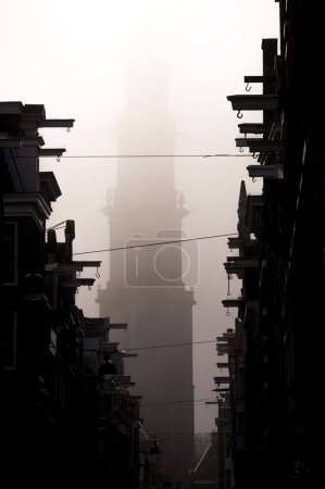 Photo for Foggy morning in Amsterdam with the Westerkerk church in the background. - Royalty Free Image
