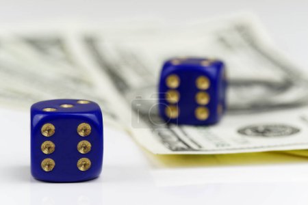 Two blue dices and American dollars on white background