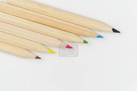 Set of colored pencils on a white background arranged in a row