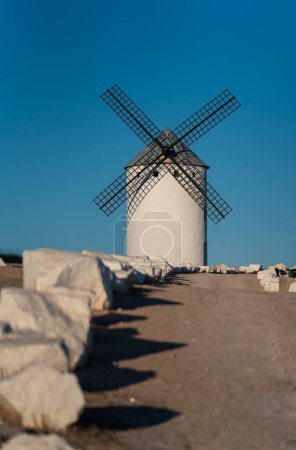 Photo for Stone delimited track to vintage Don Quixote windmill - Royalty Free Image