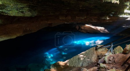Mystical cave with natural blue light offers a serene atmosphere.