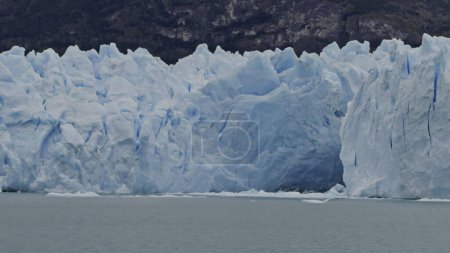 Boat tours mesmerizing glacier with ice caves in arctic scenery.