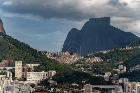 Iconic Rocinha favela lies at Two Brothers hill and Pedra da Gavea base in Rio de Janeiro.