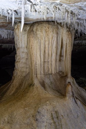 Stalactites and stalagmites form an eerie landscape in a enigmatic cave.