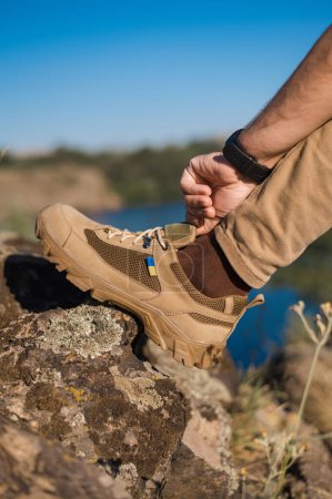 Trekking shoes with the Ukrainian flag. Military footwear. Sneakers for mountain terrain