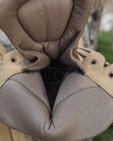 Photo for High-top lace-up sneakers in military color. The shoes are waterproof. Composition from the inside - Royalty Free Image