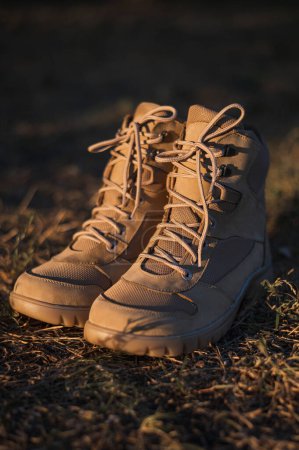Photo for High-top lace-up sneakers in military color. Tactical army specialized sneakers for field conditions - Royalty Free Image