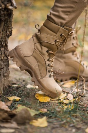 Photo for Leather waterproof boots on military. Demi-season high boots of khaki color - Royalty Free Image