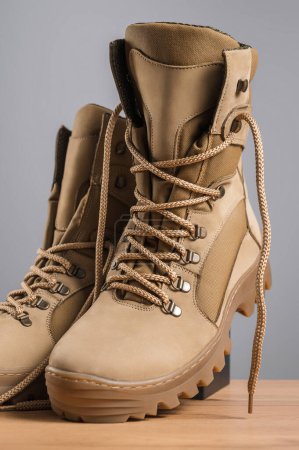 Photo for Khaki high military boots on a gray background - Royalty Free Image