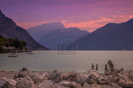 Photo for Pink colors of the sky during sunrise over Lake Garda - Royalty Free Image