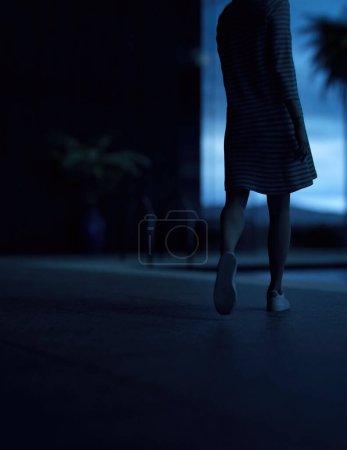 Woman in sweater dress walks to a pool on a terrace of a house. Rear view. 3D render.