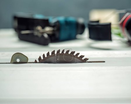Photo for Saw table with saw blade, jig saw and hearing protector. - Royalty Free Image