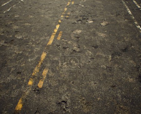 Photo for Worn out rough tarmac of an american highway. - Royalty Free Image
