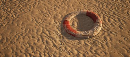 Photo for Old worn lifebuoy lying in rippled sand of beach. - Royalty Free Image