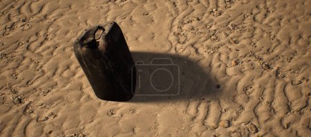 Photo for Plastic black container lying in rippled sand of beach. - Royalty Free Image