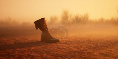 Foto de Bota vaquera perdida en el paisaje desolado brumoso del desierto. - Imagen libre de derechos