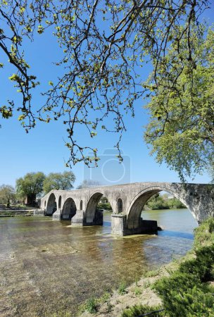 arta arched bridge in arahthos river greece in spring season