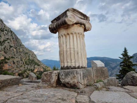 Photo for Delphi greece acanthus column with female danceres ancient  greece evening clouds summer - Royalty Free Image