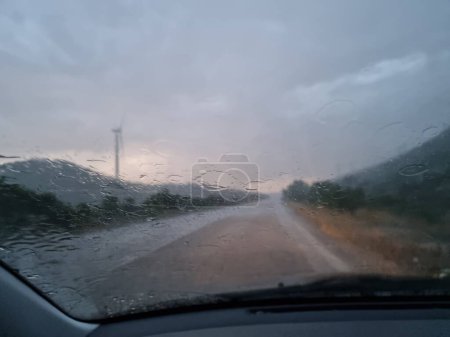 Photo for Rain road  in the evening storm bad weather travelling tornado wind generators - Royalty Free Image