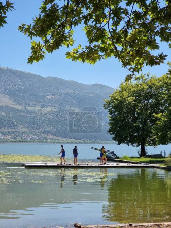 Photo for Rowing rowers trainnng in lake pamvotis under trees  of ioannina in summer season greece - Royalty Free Image