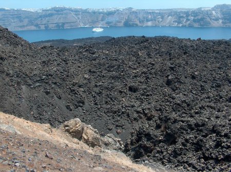 volcano in santorini greece thirasia blue sea black rocks