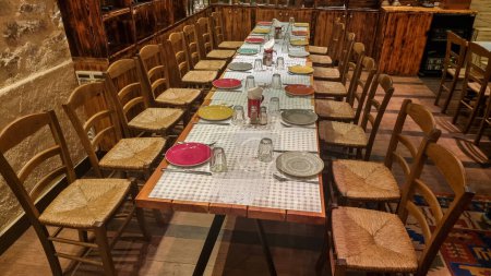 big table in restaurant with plates spoons and forks in warm wooden room place