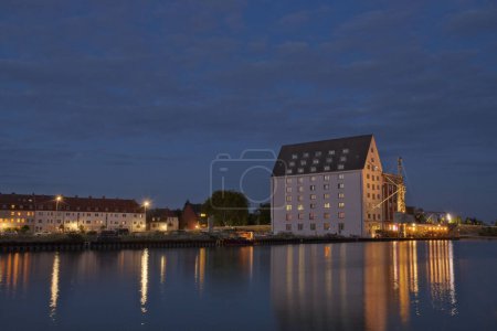 Photo for House illuminated at sunset in the harbor of Munster, Germany. - Royalty Free Image