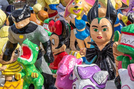 Photo for Cuenca, Ecuador - December 29, 2022: Paper mache dolls or Monigotes depicting different heroes and characters for sale in a street market to be burn out  at midnight to celebrate New Year - Royalty Free Image