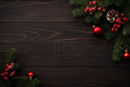 Photo for Christmas background on wooden. Fir tree brunch and red decorations flat lay with copy space. - Royalty Free Image