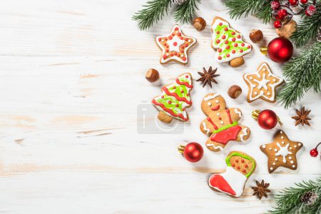 Foto de Christmas gingerbread with decorations on white wooden table. Christmas baking. Top view with copy space. - Imagen libre de derechos