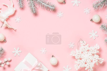Photo for Christmas flat lay background at pink. Fir tree, present box and white christmas decorations. Top view with copy space. - Royalty Free Image