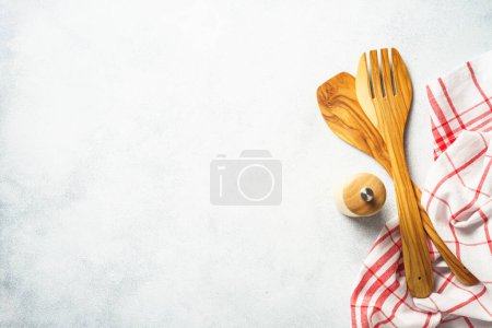 Foto de Kitchen utensil and tablecloth on white stone table. Top view with copy space. - Imagen libre de derechos
