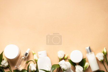Photo for Natural cosmetic products. Cream, serum, tonic with green leaves and flowers. Flat lay image with copy space. - Royalty Free Image