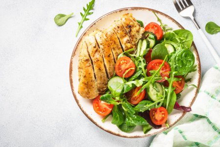 Photo for Healthy food plate. Green salad with chicken fillet on white. Top view with copy space. - Royalty Free Image